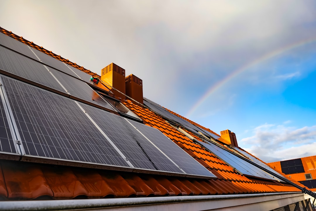 services-01 a-solar-panel-on-a-roof-with-a-rainbow-in-the-background-0syvpkyzc-m